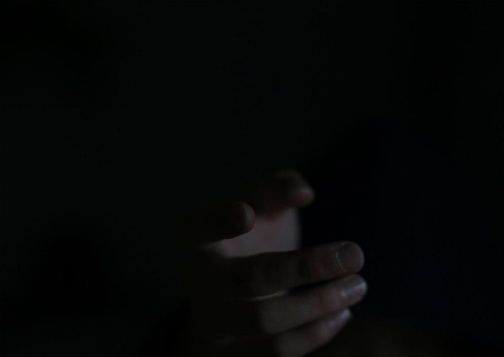 Dark background, close up of a hand